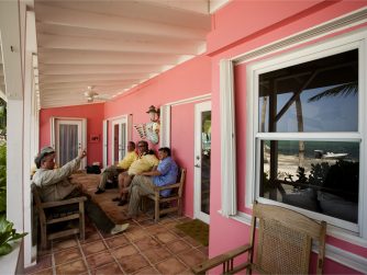 Lodge experience guests hanging out on the patio chatting PH MARCOS FURER scaled