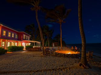 The Lodge at night chilling by the fire pit PH Hatch Magazine 1 scaled